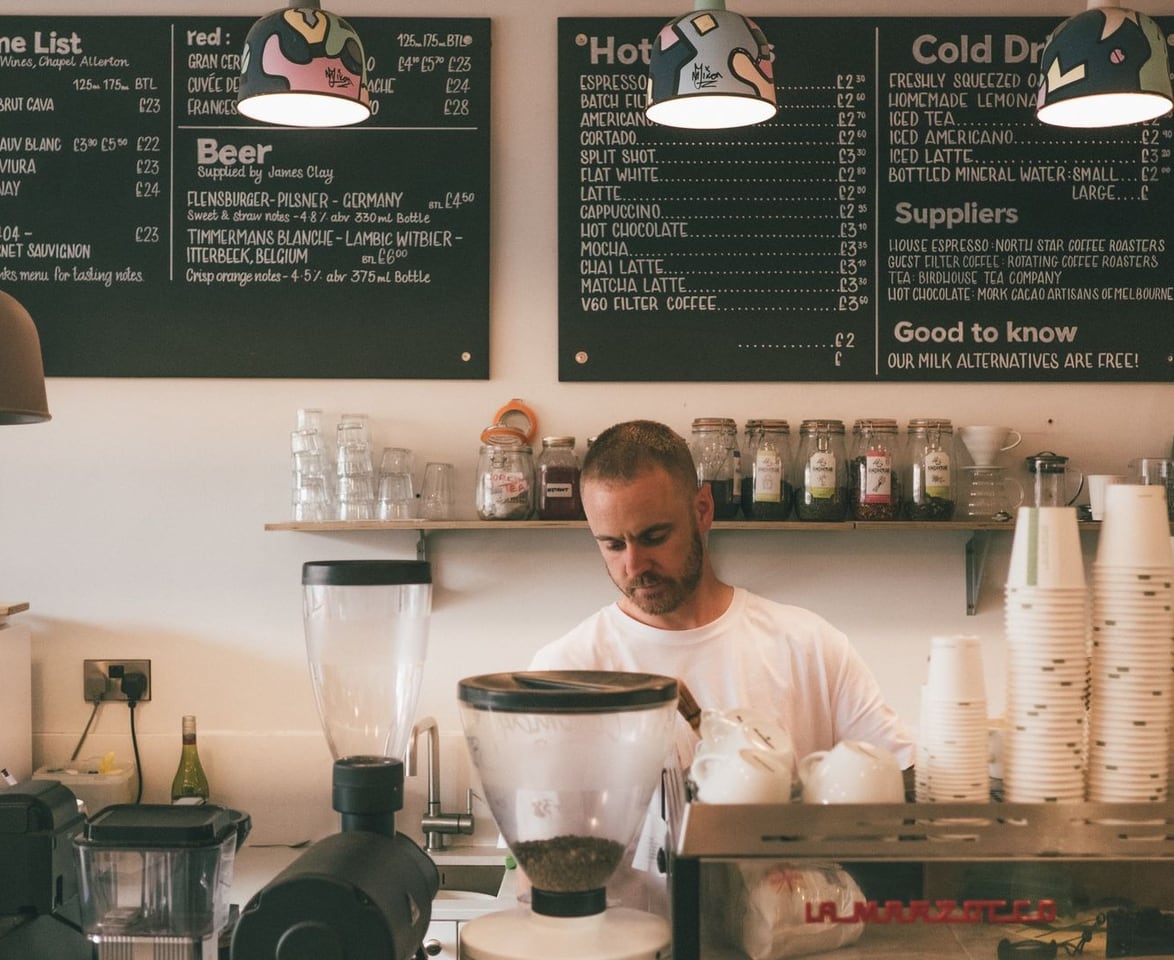 A business owner at work behind the counter